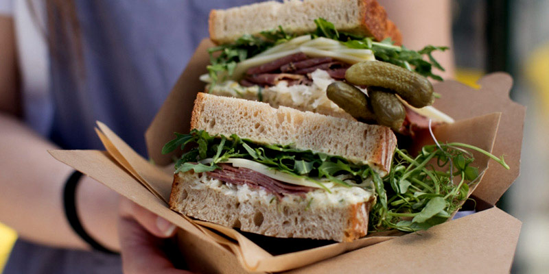 Woman holding a large sandwich