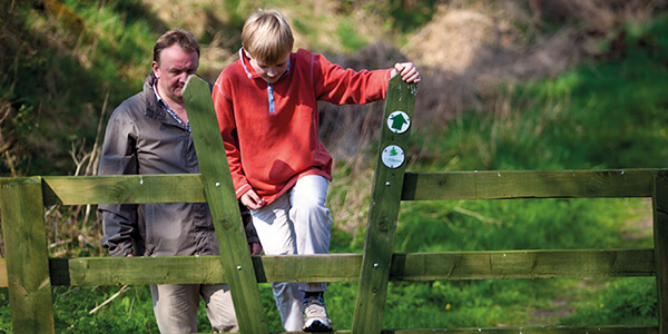 Man and his son on a stile