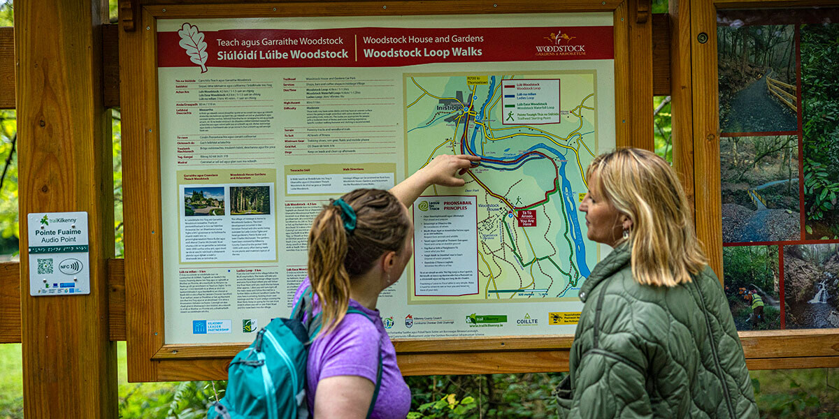 Two women looking at a trail map