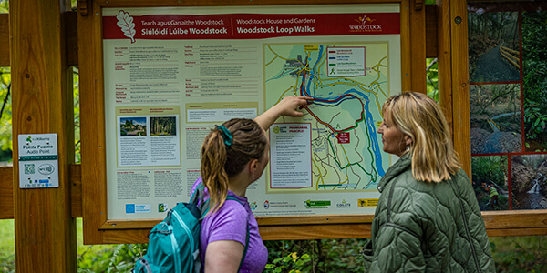 Hikers looking at information map